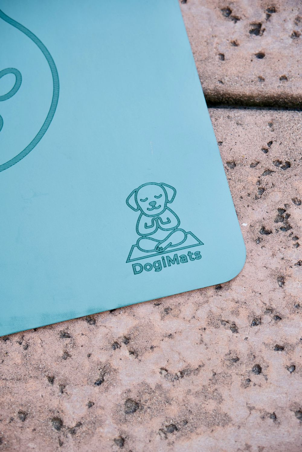 Close-up of the DogiMats logo engraved on a mat